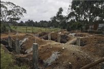 The columns are dug till solid rock and protrude slightly above the ground level.