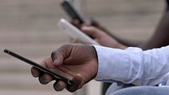 Kenyan on a mobile phone