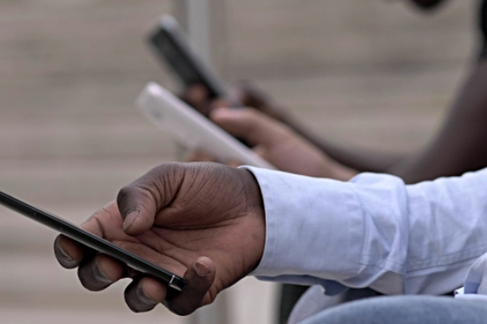 Kenyan on a mobile phone