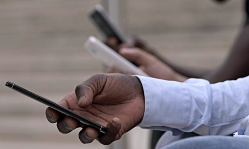 Kenyan on a mobile phone