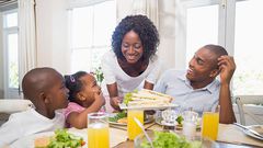 Happy family enjoying meal(orthobridgeorthopedics)