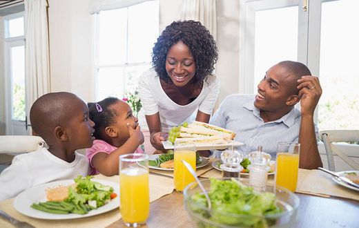 Happy family enjoying meal(orthobridgeorthopedics)