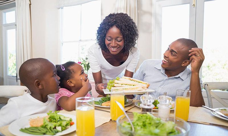 Happy family enjoying meal(orthobridgeorthopedics)