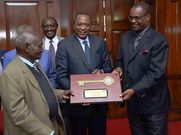 Former President Uhuru Kenyatta and former Nairobi Governor Evans Kidero present the ‘Key to the City’ to pioneer businessman Mzee Gerald Gikonyo at State House in Nairobi, April 15, 2017.