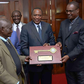 Former President Uhuru Kenyatta and former Nairobi Governor Evans Kidero present the ‘Key to the City’ to pioneer businessman Mzee Gerald Gikonyo at State House in Nairobi, April 15, 2017.