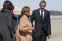 Marian Robinson, mother of first lady Michelle Obama, center left, smiles as she boards Air Force One with former President Barack Obama en route to the commemoration of the 50th anniversary of “Bloody Sunday,” a landmark event of the civil rights movement, from Andrews Air Force Base, Md., March 7, 2015.