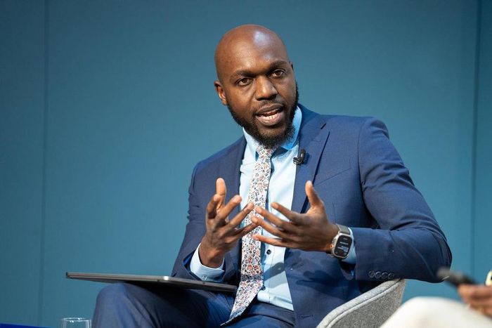 Larry Madowo moderating a panel discussion at the Word Economic Forum stage in January 2022