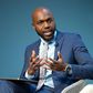 Larry Madowo moderating a panel discussion at the Word Economic Forum stage in January 2022