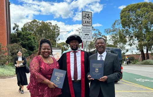 Moses Wetangula with son after being conferred with PhD