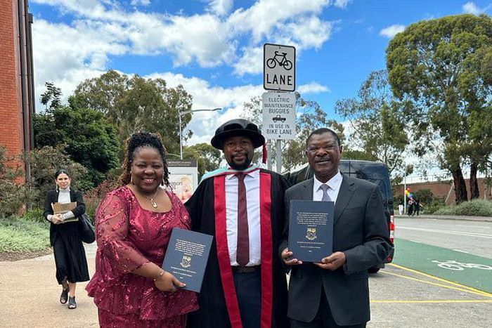 Moses Wetangula with son after being conferred with PhD