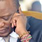 President Uhuru Kenyatta using a mobile phone