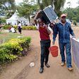 A form one student arrives at Kerugoya Boys Secondary School in Kirinyaga county accompanied by his parent. Photo credit: George Munene | Nation Media Group