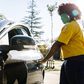 Young woman opening the car door. Credit: Fotostorm