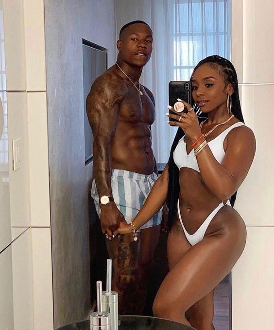 Couple in beachwear posing in front of mirror/Courtesy