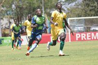 KCB midfielder Henry Onyango vies for the ball with Mathare United player