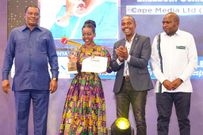 Elizabeth Ochieng' receives her Journalist of the Year award on May 3, 2024. Flanking her are AG Justin Muturi, MP John Kiarie & MCK CEO David Omwonyo