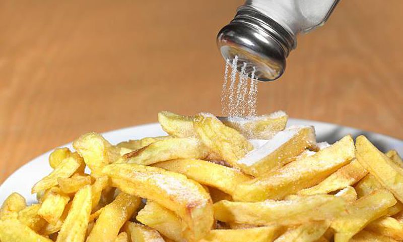 Sprinkling salt to food