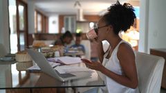Woman working from home and drinking coffee | Credit: FG Trade