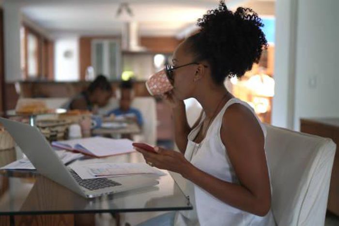 Woman working from home and drinking coffee | Credit: FG Trade