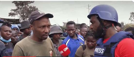 Larry Madowo comes to the aid of a man during maandamano on July 20 in Kamukunji area, Nairobi