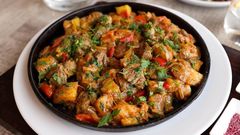 Beef stew garnished with cilantro [Image Credit: Valeria Boltneva]
