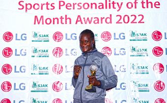Sarah Achieng poses with her trophy/HANDOUT
