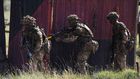 Soldiers take up position as they take part in a simulated military exercise of the British Army Training Unit in Kenya (BATUK) together with the Kenya Defence Forces (KDF) at the ol-Daiga ranch, high on Kenya's Laikipia plateau on March 27, 2018. (TON...