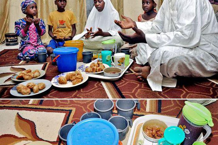 A father and his family sit around a meal for Iftar during Ramathan