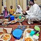 A father and his family sit around a meal for Iftar during Ramathan