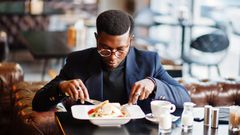 A well-dressed man dining in a restaurant