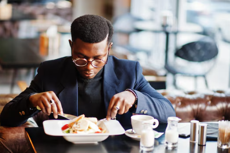 A well-dressed man dining in a restaurant