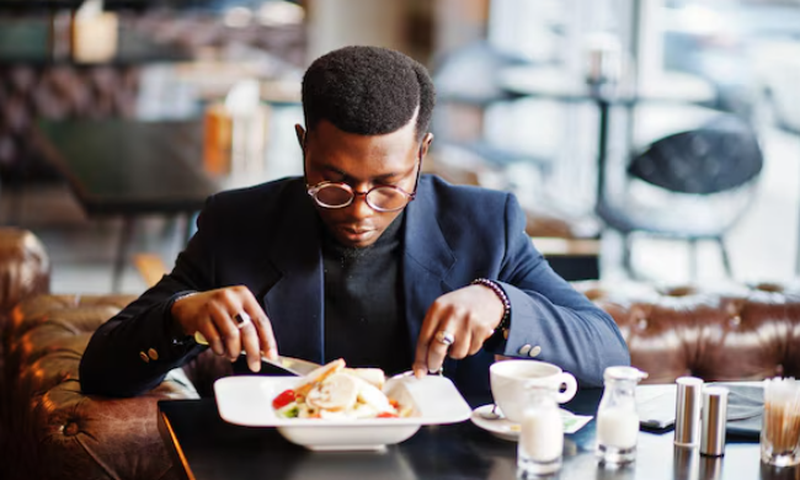 A well-dressed man dining in a restaurant