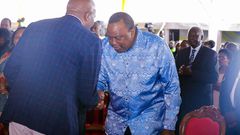 Retired President Uhuru Kenyatta greets CS Moses Kuria during the Episcopal Ordination for Bishops elect Simon Peter Kamomoe and Wallace Ng'ang'a at St Mary's Msongari.