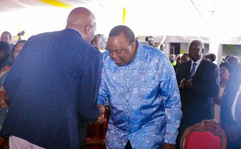 Retired President Uhuru Kenyatta greets CS Moses Kuria during the Episcopal Ordination for Bishops elect Simon Peter Kamomoe and Wallace Ng'ang'a at St Mary's Msongari.