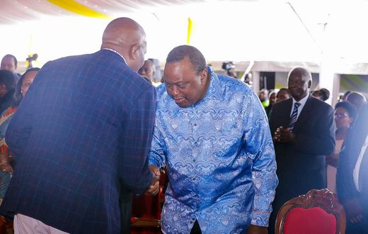Retired President Uhuru Kenyatta greets CS Moses Kuria during the Episcopal Ordination for Bishops elect Simon Peter Kamomoe and Wallace Ng'ang'a at St Mary's Msongari.