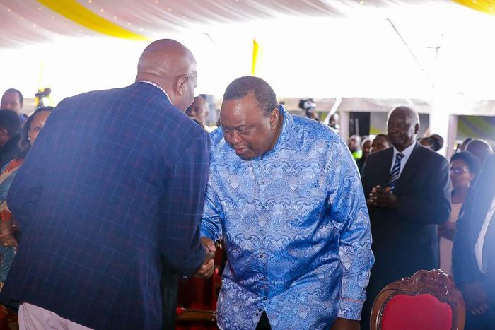 Retired President Uhuru Kenyatta greets CS Moses Kuria during the Episcopal Ordination for Bishops elect Simon Peter Kamomoe and Wallace Ng'ang'a at St Mary's Msongari.