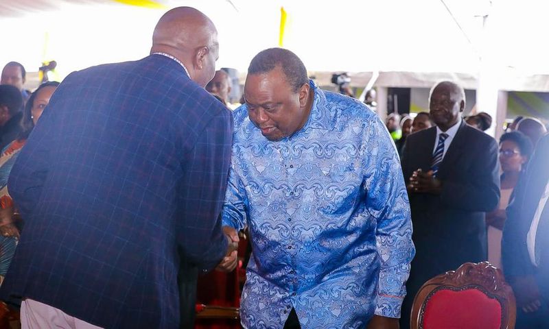 Retired President Uhuru Kenyatta greets CS Moses Kuria during the Episcopal Ordination for Bishops elect Simon Peter Kamomoe and Wallace Ng'ang'a at St Mary's Msongari.
