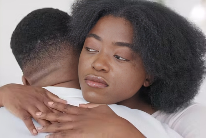 A woman consoling a man