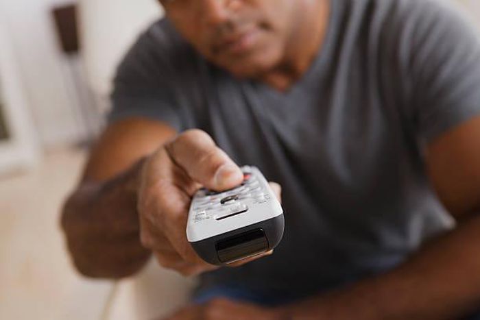 A man holding a remote control