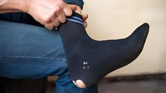 Man wearing torn socks