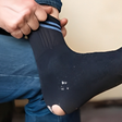 Man wearing torn socks