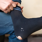 Man wearing torn socks
