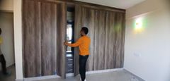 Stephen Kasolo showing his new apartment