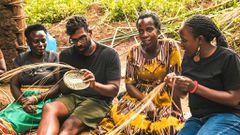 Romesh learning about Ugandan artwork