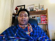 Narok Senator Ledama Olekina attending a virtual Senate session in traditional attire