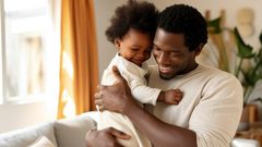 A father bonding with his baby at home