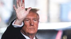 Former President Donald Trump waves to the crowd outside Trump Tower on Tuesday. Red marks are clearly visible on his hand.Charly Triballeau/AFP/Getty Images