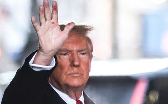 Former President Donald Trump waves to the crowd outside Trump Tower on Tuesday. Red marks are clearly visible on his hand.Charly Triballeau/AFP/Getty Images