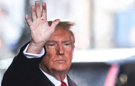 Former President Donald Trump waves to the crowd outside Trump Tower on Tuesday. Red marks are clearly visible on his hand.Charly Triballeau/AFP/Getty Images