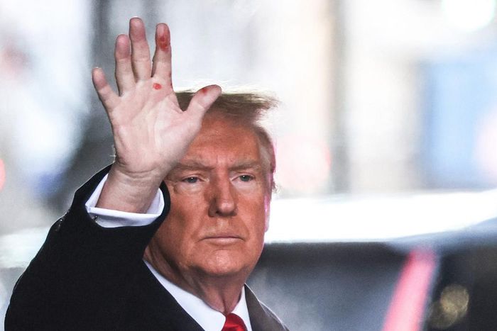 Former President Donald Trump waves to the crowd outside Trump Tower on Tuesday. Red marks are clearly visible on his hand.Charly Triballeau/AFP/Getty Images
